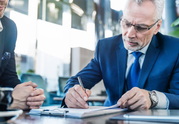 A man signs a document